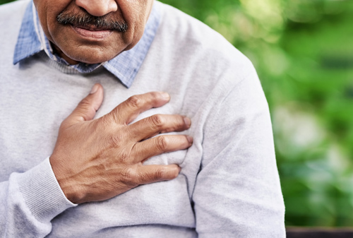 Man holding his arm on his chest