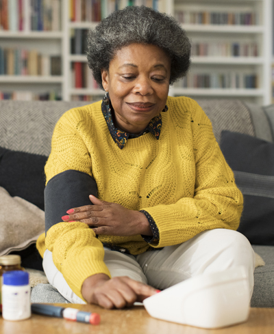 A woman taking her blood pressure