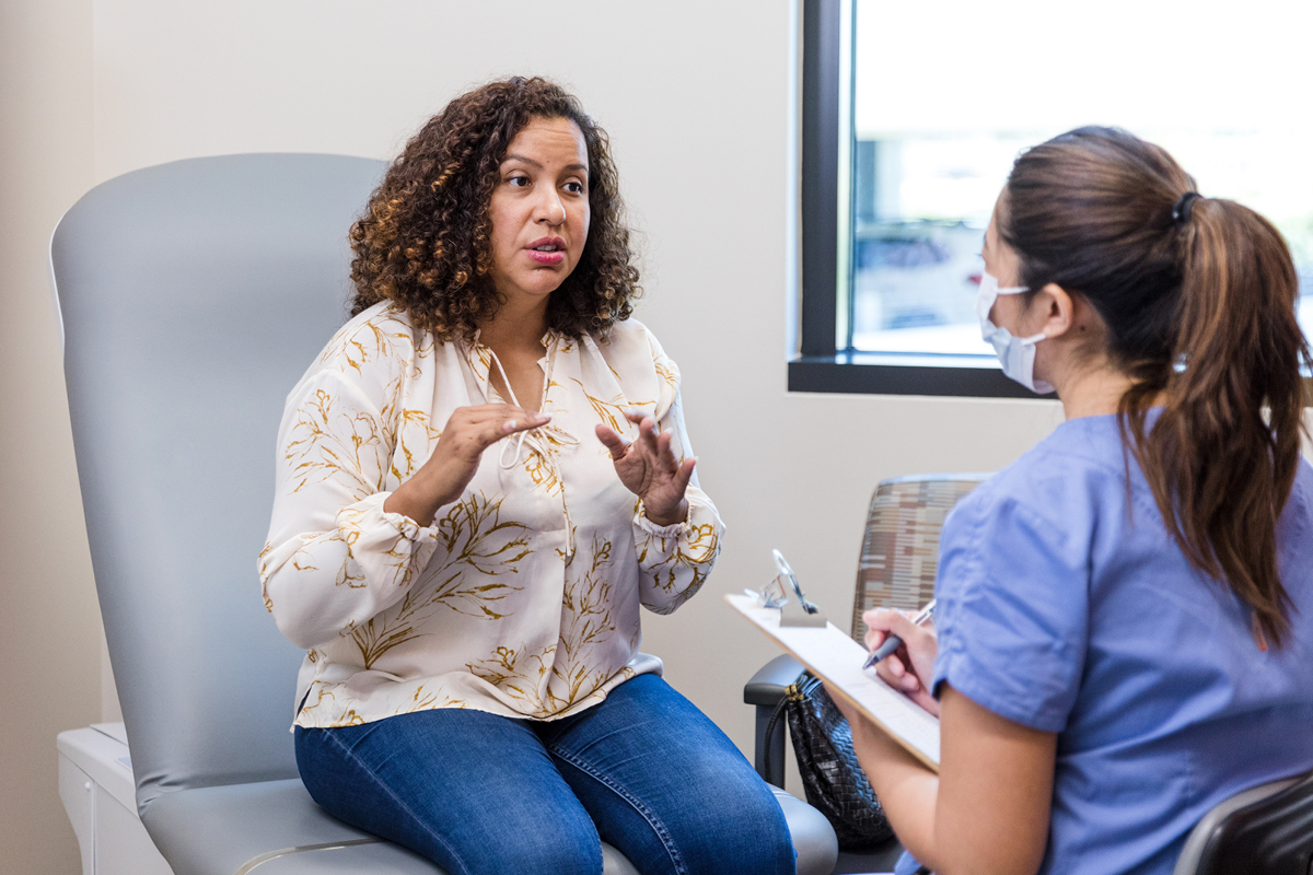 A woman talking to a healthcare professional at a medical office