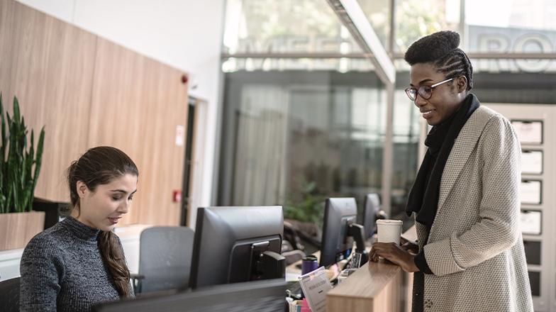 Woman checking in at front desk