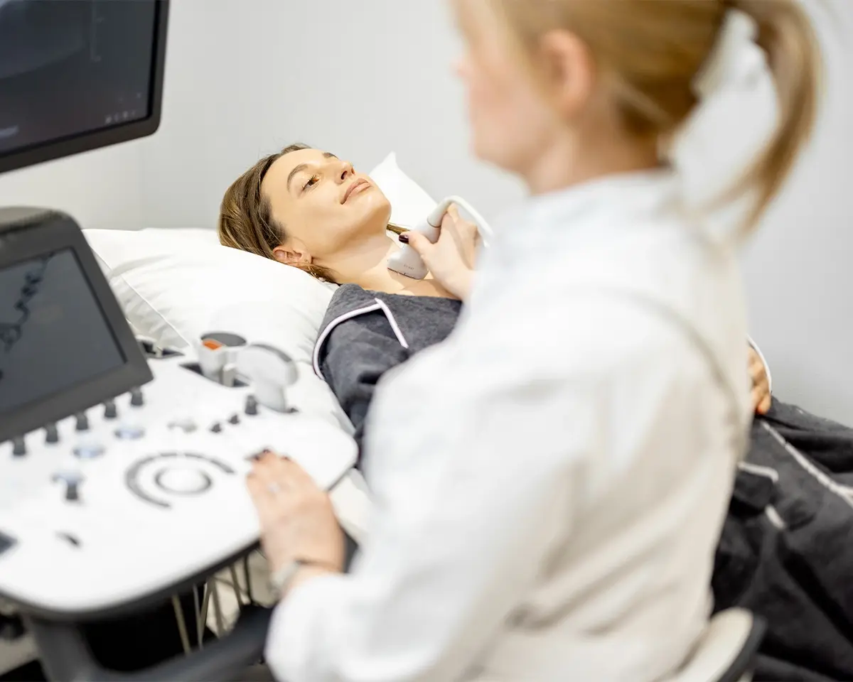 Woman getting scan on her neck by a technician