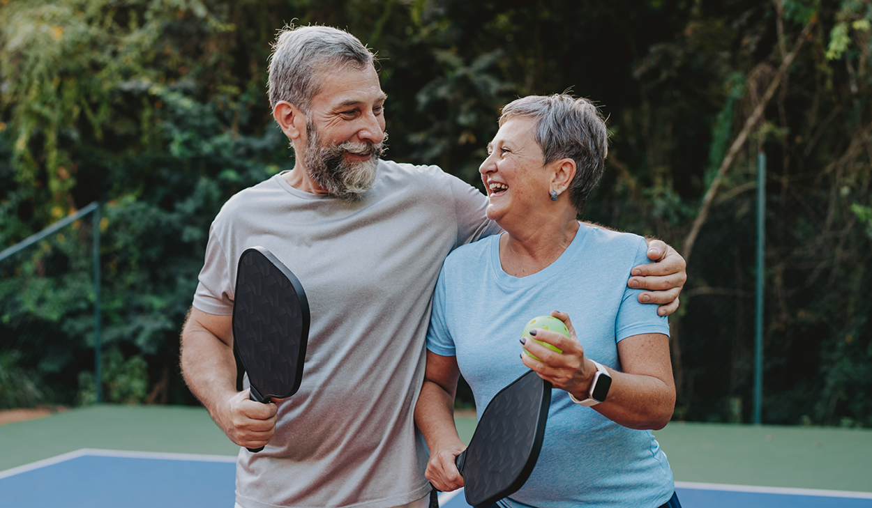 Older couple smiling after a pickleball game
